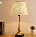 Retro-style alloy metal table lamp with LED light on a wooden surface.
