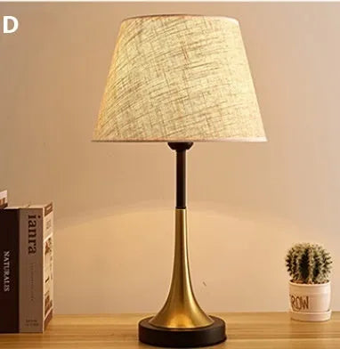 Retro-style alloy metal table lamp with LED light on a wooden surface.