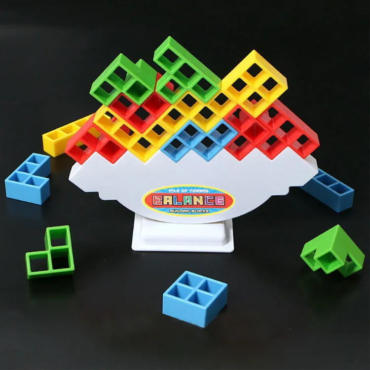 Plastic balance stacking game with 16 coloured blocks, chassis and base on a table