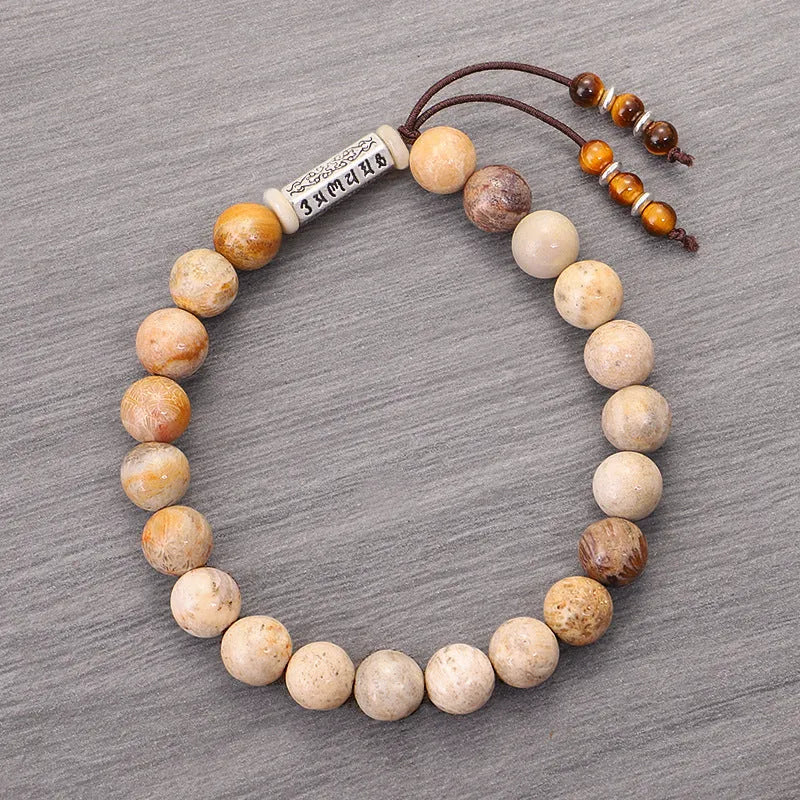Handmade wood-colour stone bracelet with retro design on a wrist.
