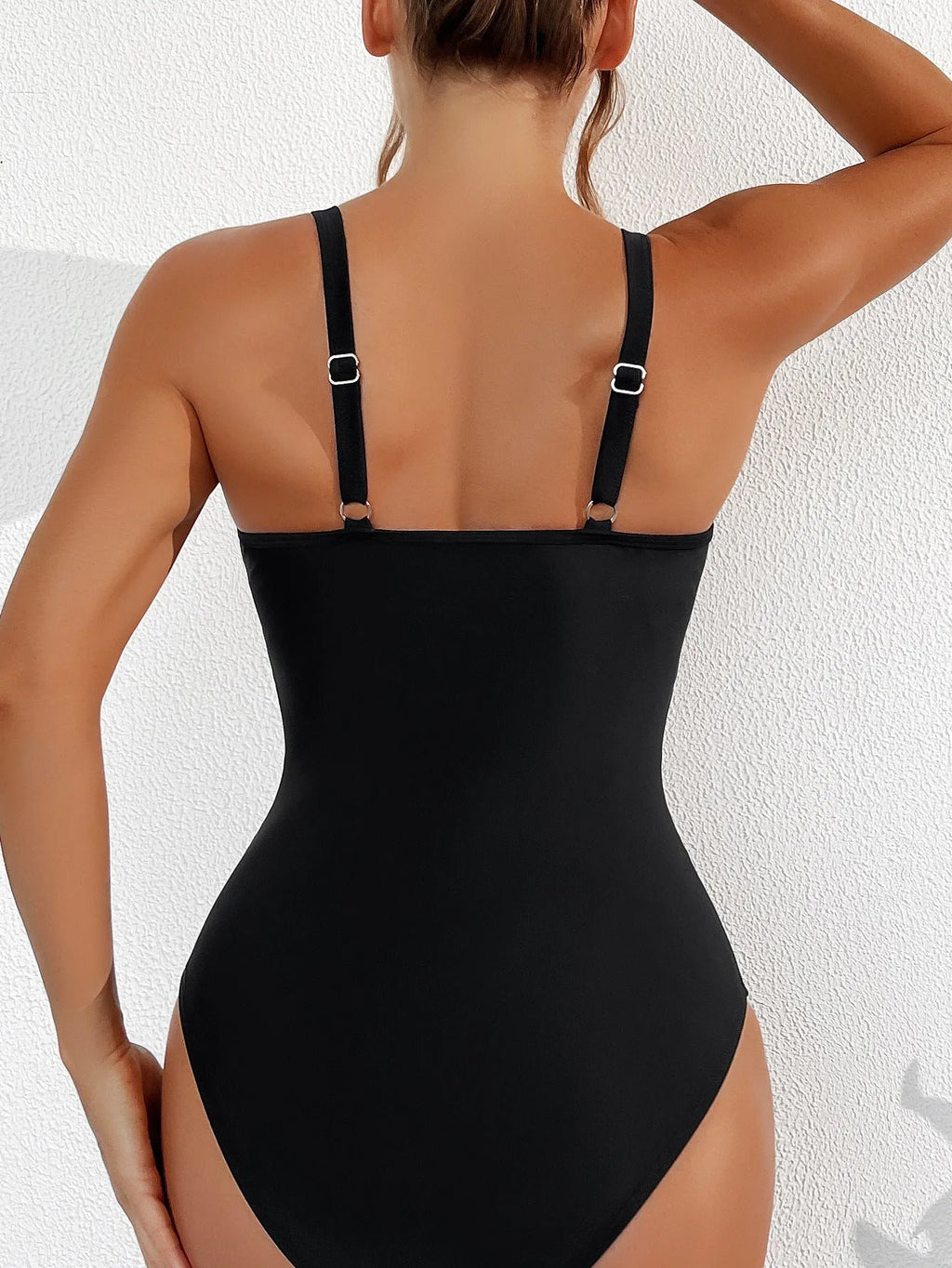 Black women's one-piece swimsuit with halter neck and mesh panel detailing.