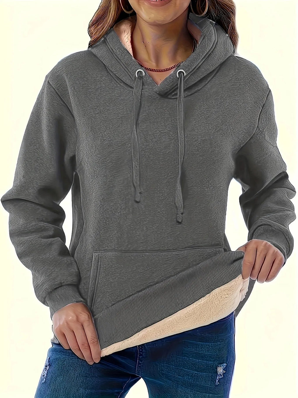 Women's loose-fit grey hooded sweater with a front pocket and a textured 3D pattern.