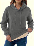 Women's loose-fit grey hooded sweater with a front pocket and a textured 3D pattern.