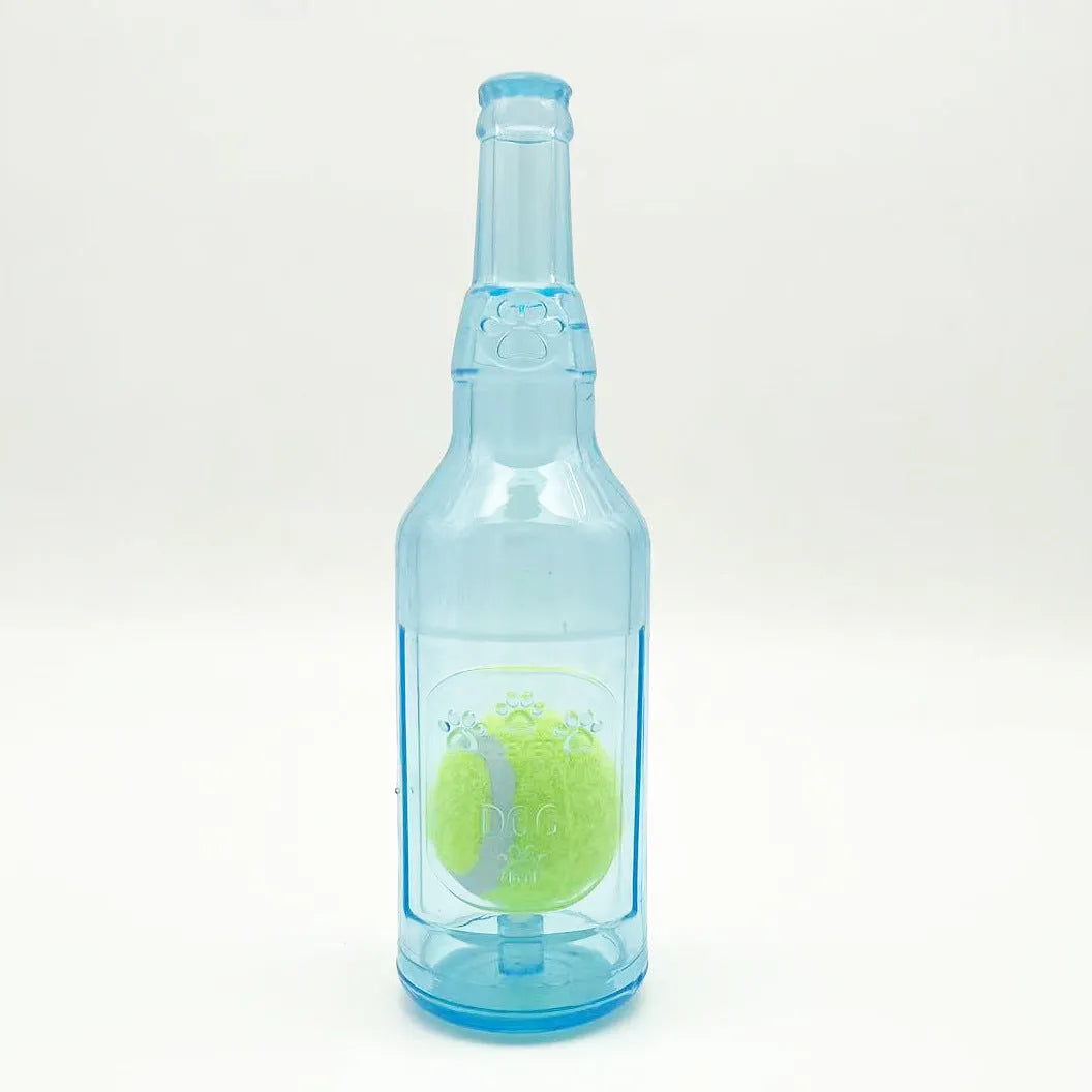 Blue water bottle dog toy with squeaker and internal tennis ball on grass