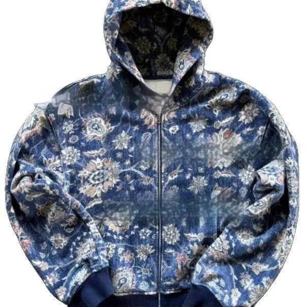 Man wearing a blue loose-fit zip-up hoodie with a hood, shown in a casual setting.