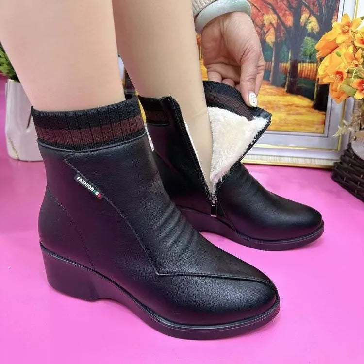 Women's soft leather ankle boots with mid heel, side zipper, and square heel in black