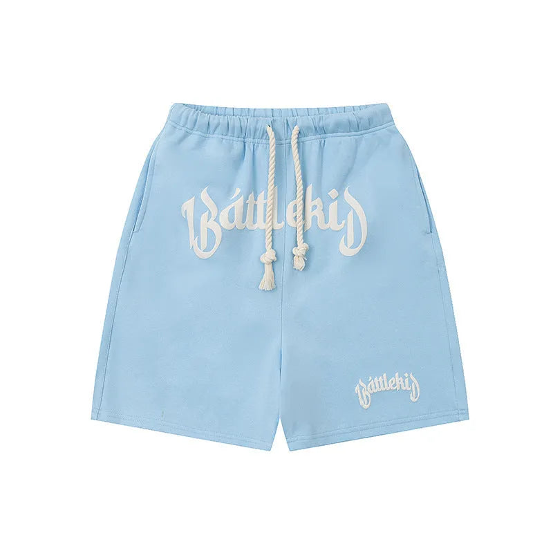Loose-fit cotton blend cropped shorts in black, shown in a casual streetwear style.