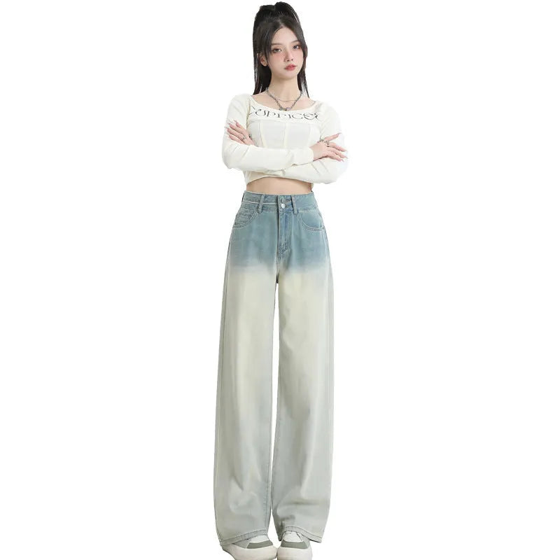 A pair of women's gradient blue straight-leg denim trousers with a wide leg opening, laid flat.