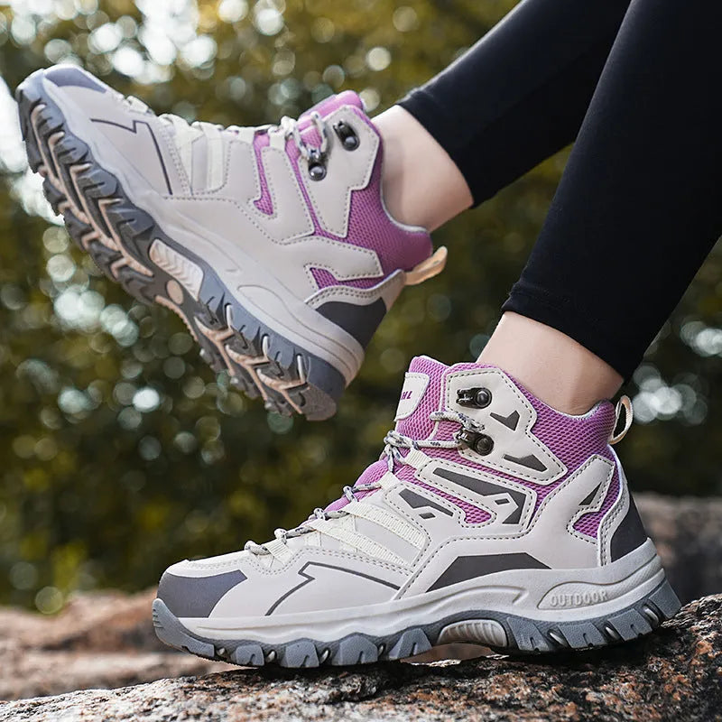 Flannel upper hiking sneakers with rubber soles in light brown colour on a rocky path.