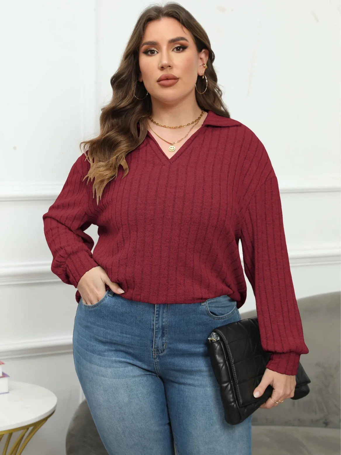 Plus size women's gray fleece pullover with a polo collar and lantern sleeves on a hanger.
