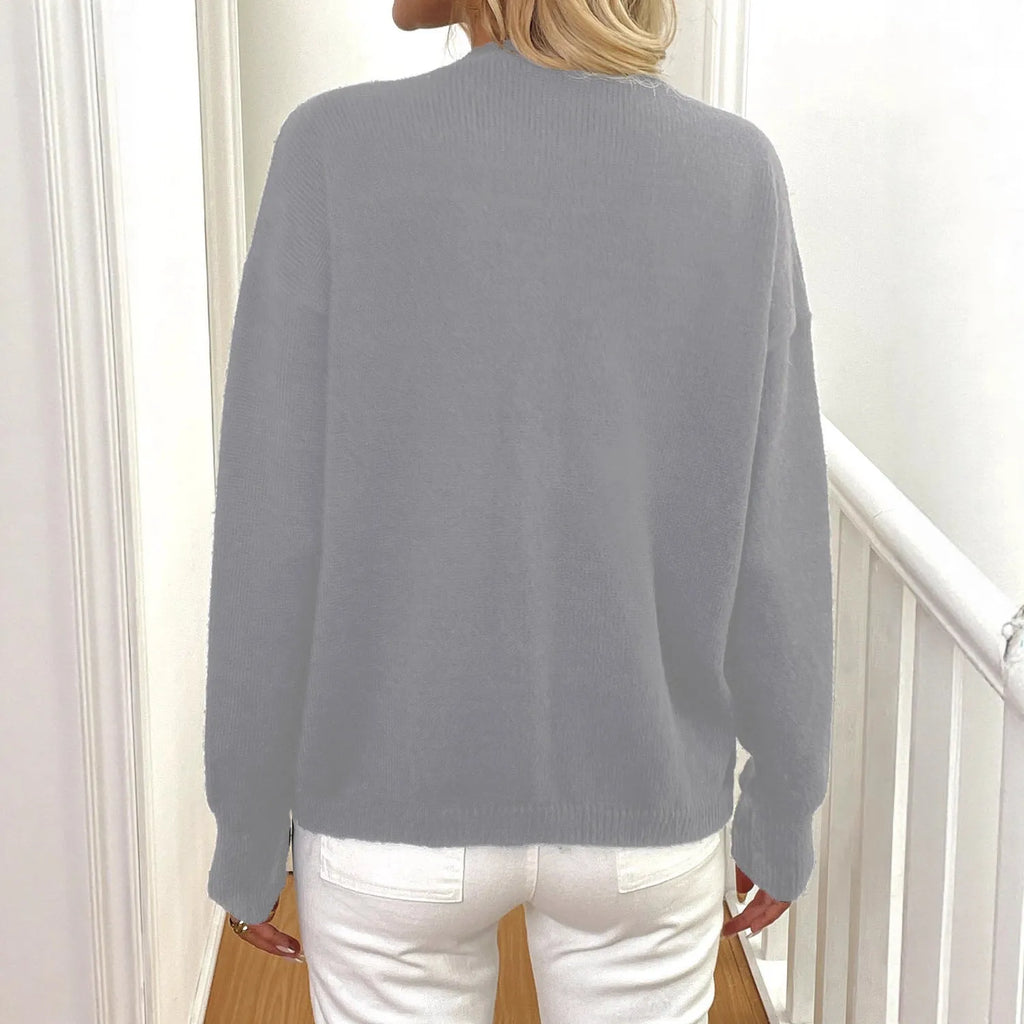A grey women's deer plush long sleeve sweater coat with Princess sleeves on a hanger.