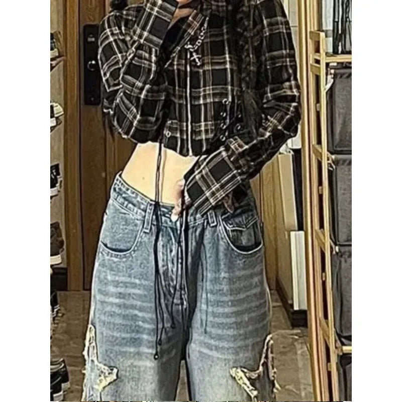 Blue high-waisted wide-leg denim trousers on a hanger, showing the straight-leg silhouette.