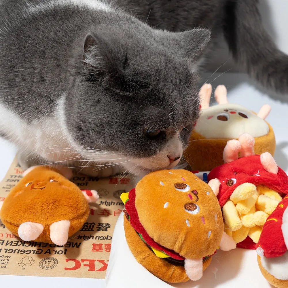 Cat mint teething toy shaped like a hamburger and chicken leg, made from soft plush fabric, on a light background.