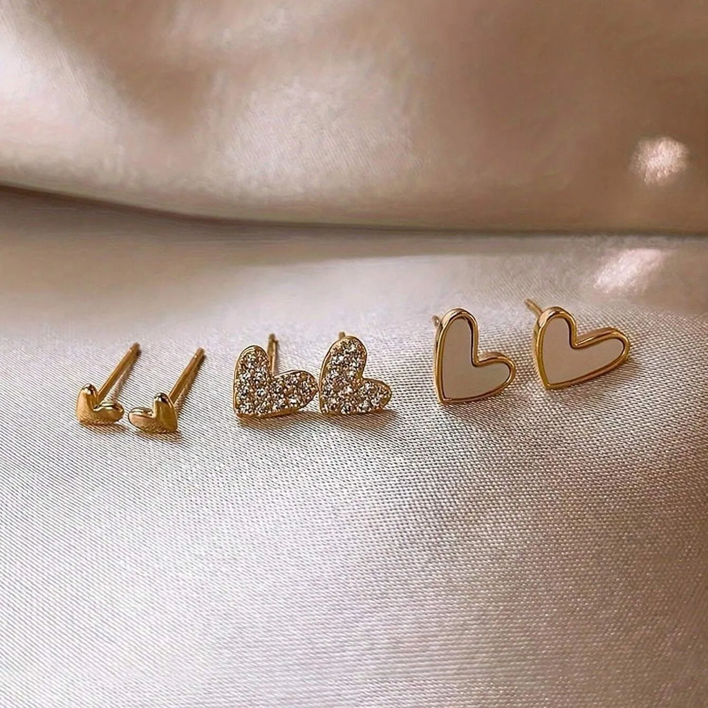 Three pairs of heart-shaped girly drop earrings in gold, black, pink colours
