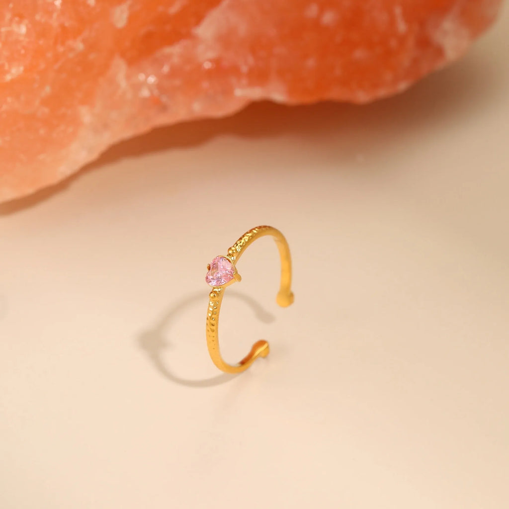 Open-ended heart-shaped ring with geometric design and zircon stones in stainless steel