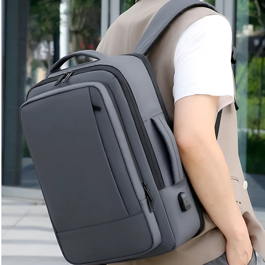 Black waterproof Oxford cloth business backpack with curved shoulder strap showing laptop compartment and 20-35L capacity.