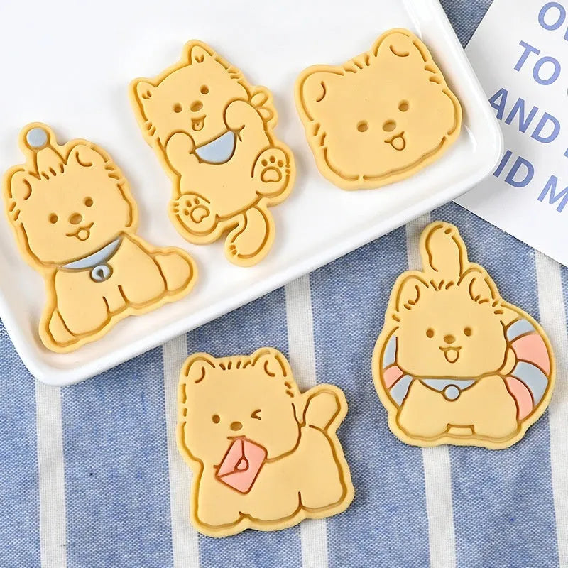 Three-dimensional plastic biscuit mould with cartoon puppy designs including birthday hat and swimming ring patterns