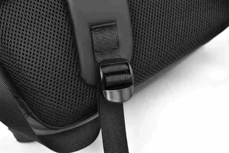 Large simple design waterproof backpack in grey with visible stitching, shown with a separate computer bag.