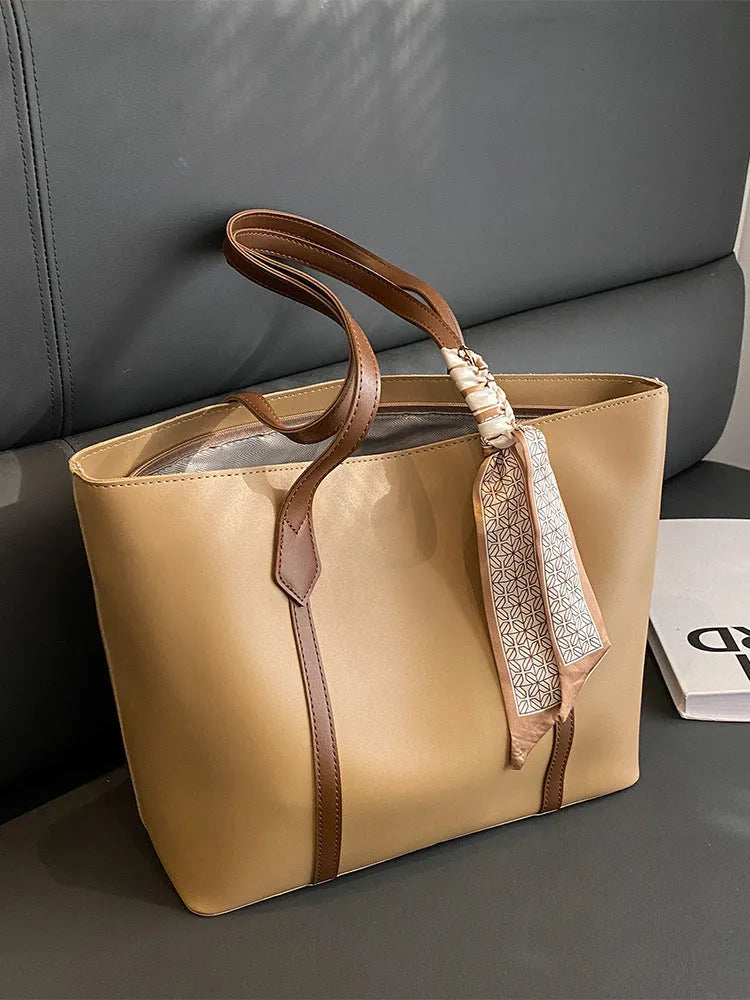 Women's large capacity soft tote bag with crossbody strap showing zipper compartment interior