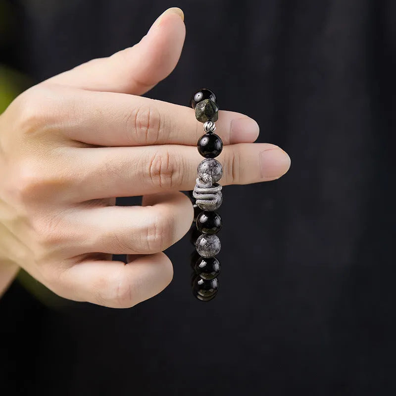 Men's S925 sterling silver snake zodiac bracelet with black obsidian charm on wrist
