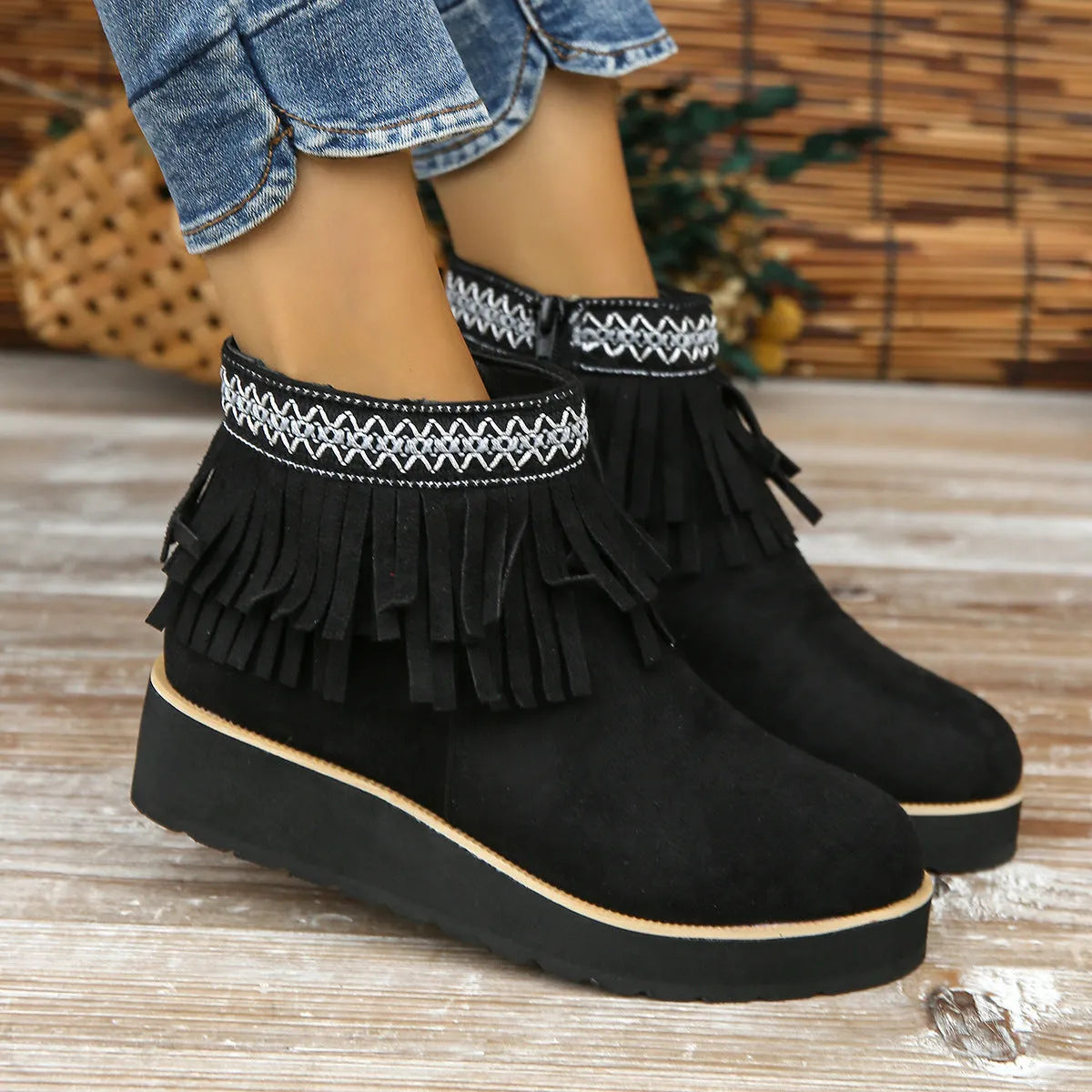 Women's black suede wedge ankle boots with tassel and side zip on a waterproof platform sole.