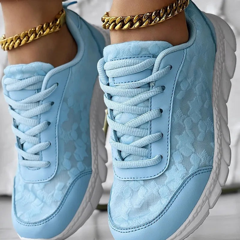 Women's casual canvas running shoes in white, black, blue, or pink with a flat heel and rounded toe.