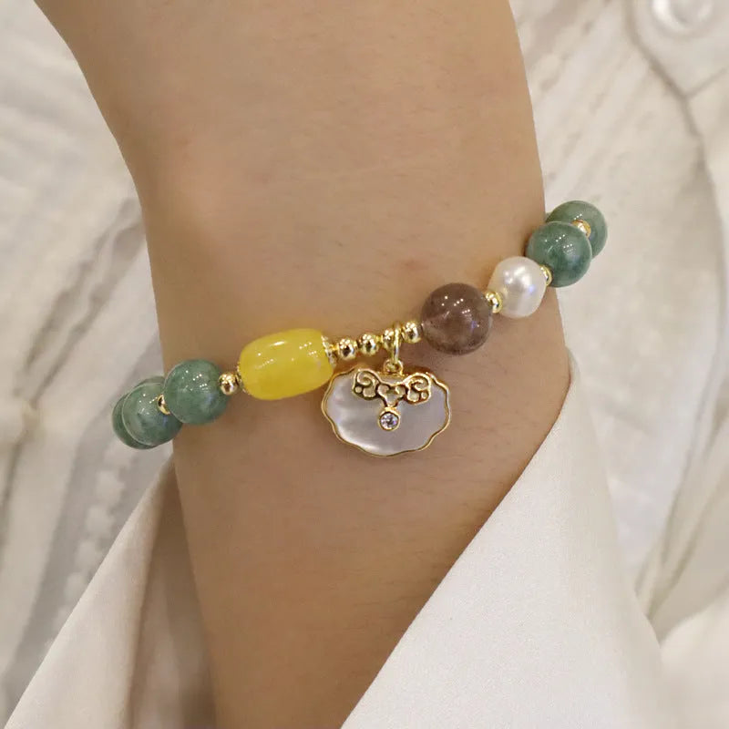 Natural green jade shell bracelet on display showing shell-shaped stone pieces in pictured colour