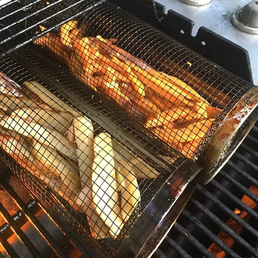 Rolling grill basket metal mesh cylinder with hooks on barbecue, containing vegetables and meat