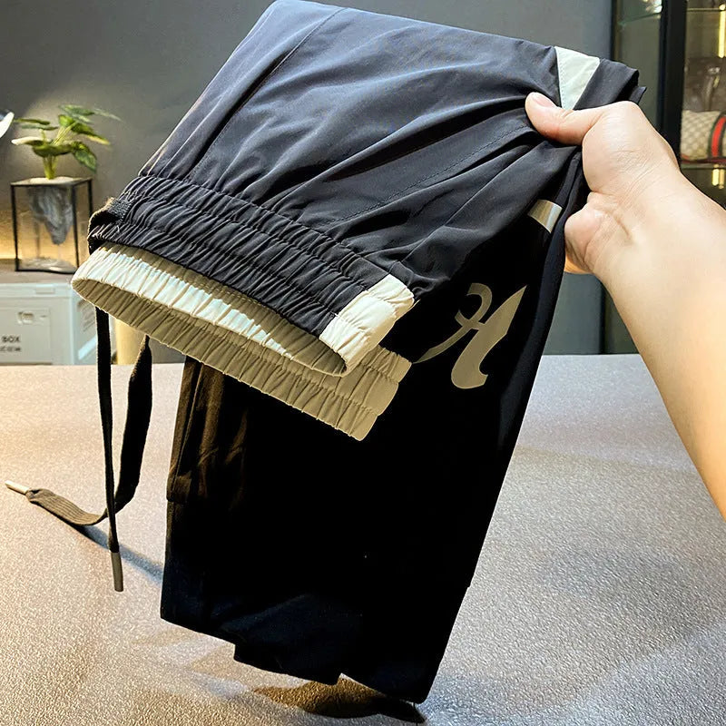 Black men's casual cropped trousers with ankle band made from ultra-thin ice silk and cotton.