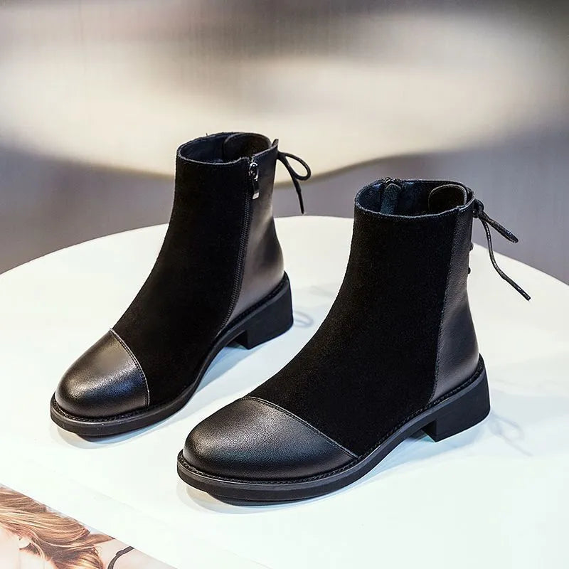 Black women's knee-high Martin boots with side zipper and round toe.