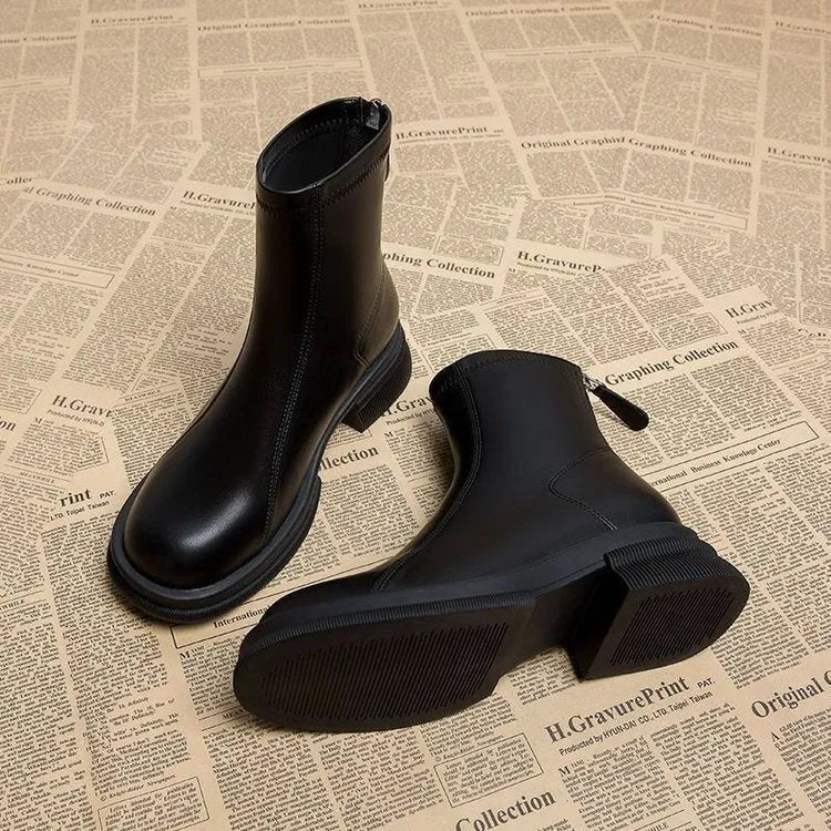 Women's black ankle boots with back zipper, flat thick heel, and round toe design