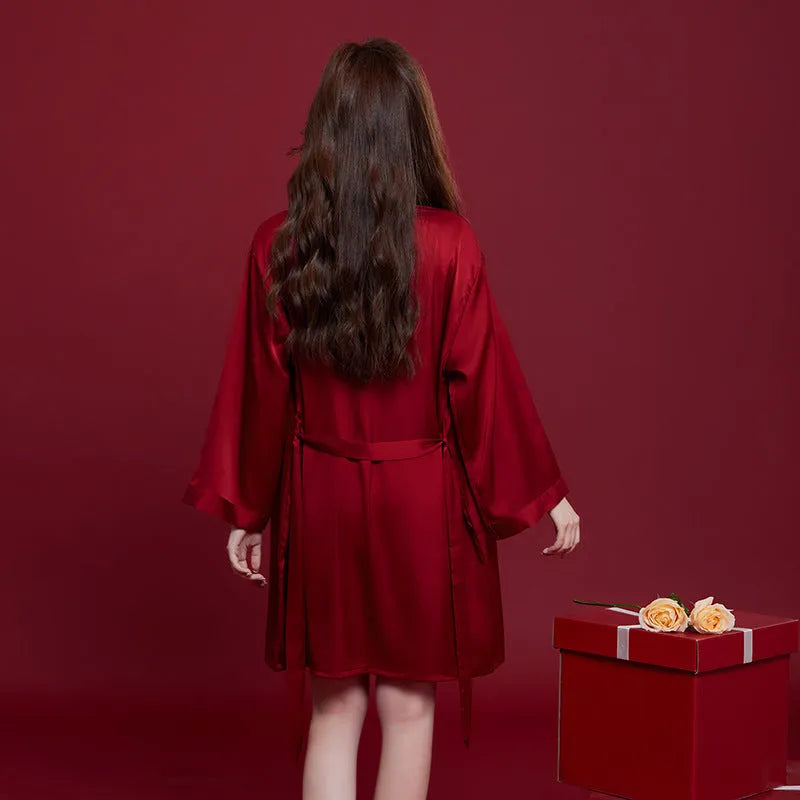 Red silk pyjama set for couples with long sleeves and trousers, shown in men's and women's matching styles