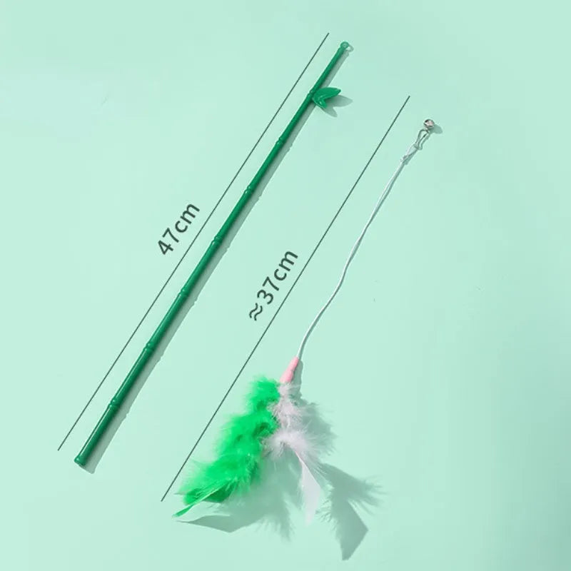 Green interactive cat feather wand toy with bells on a light background