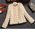 Women's short sleeved faux fur top in beige, shown on a model, with a street fashion style.