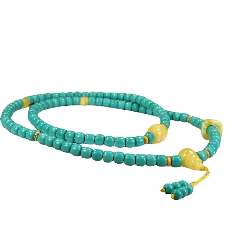 Turquoise stone pendant necklace with hand-woven mesh flower design on adjustable ball bead chain