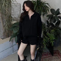 Womens creamy-white cable knit sweater and shorts suit set on a hanger
