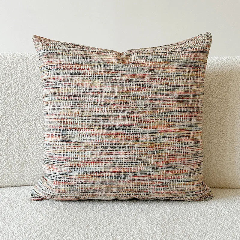 American-style amber jacquard pillow cover with paisley plant pattern, shown on a sofa.