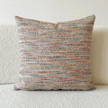 American-style amber jacquard pillow cover with paisley plant pattern, shown on a sofa.