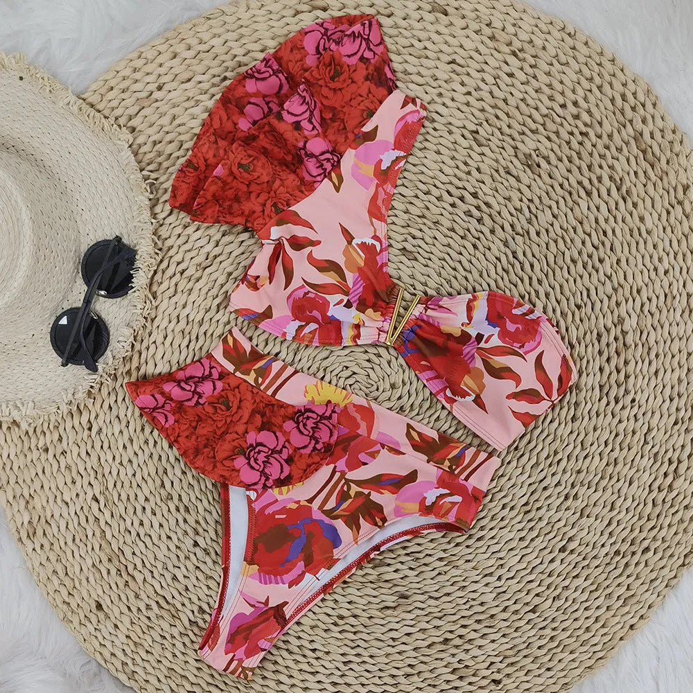 Women's pink one-shoulder ruffled bikini with high-waist briefs and red flower print