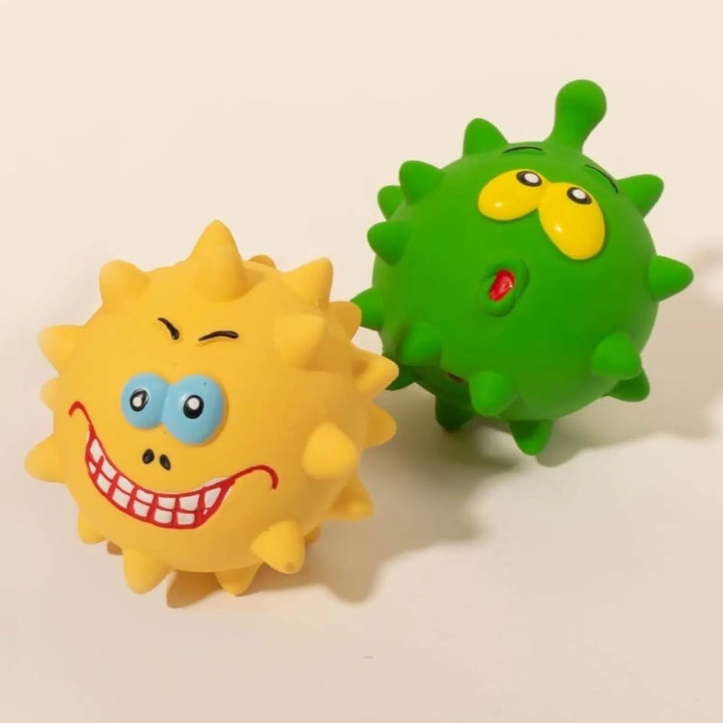 Set of four colourful latex squeaky dog balls with cute faces and textured surfaces.