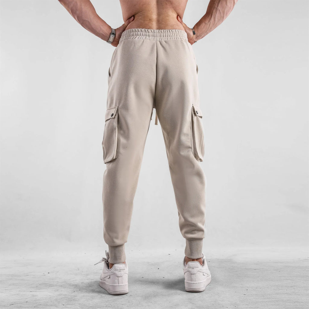 Men's loose cotton sports trousers with ankle tie detail and multiple pockets in apricot colour