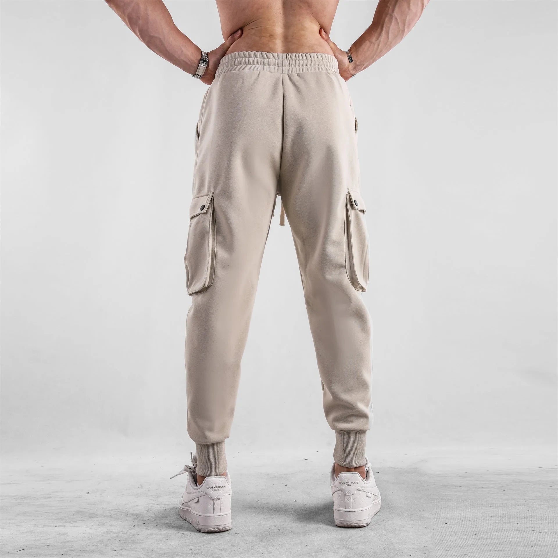 Men's loose cotton sports trousers with ankle tie detail and multiple pockets in apricot colour