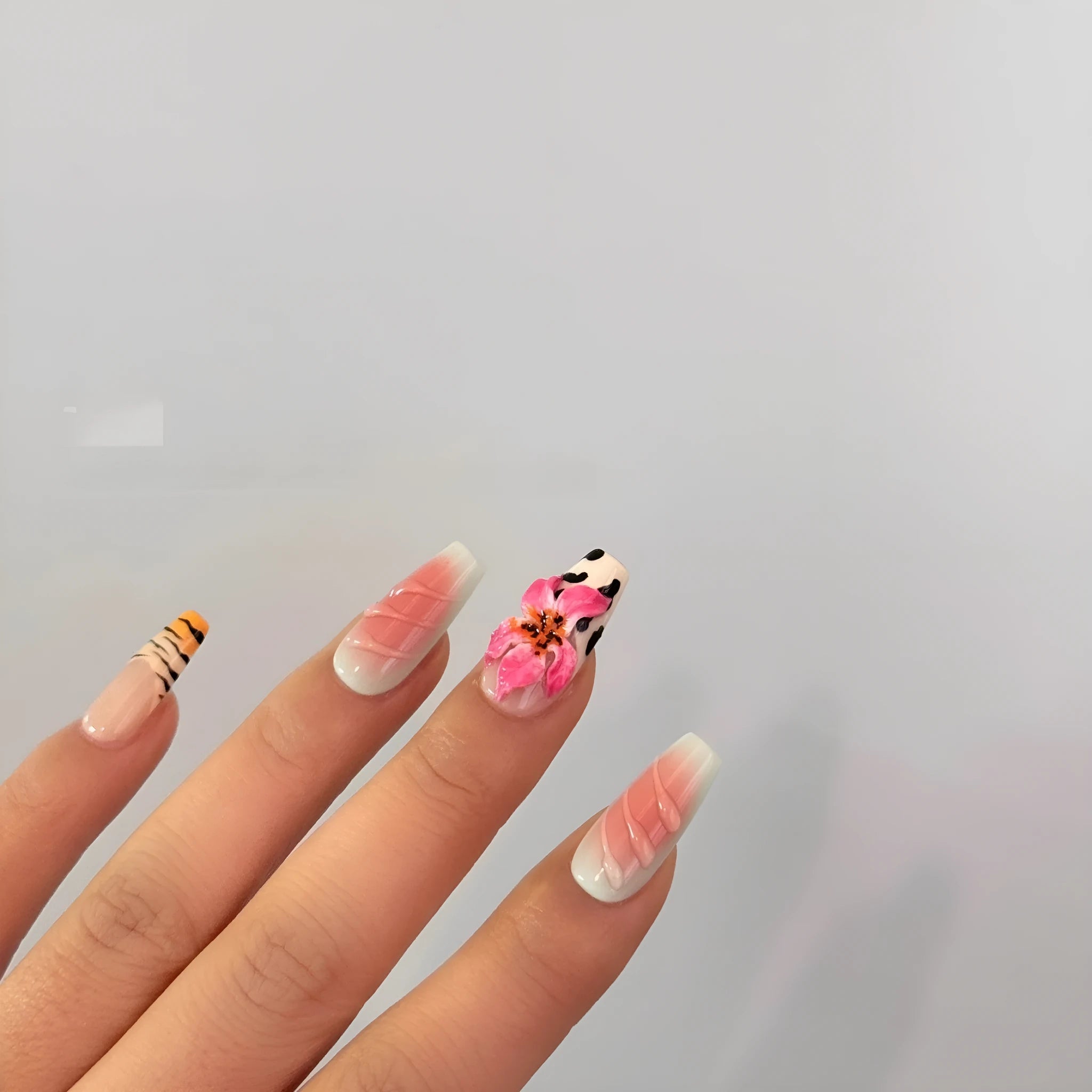 Lily hand carving acrylic nail art set featuring black and white zebra stripes with raised pink floral embossments.