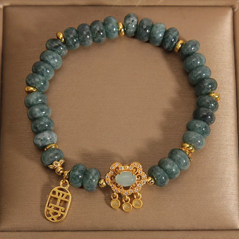 Natural emerald jade abacus bead safety lock style bracelet on women's wrist, alloy frame, green gemstone beads