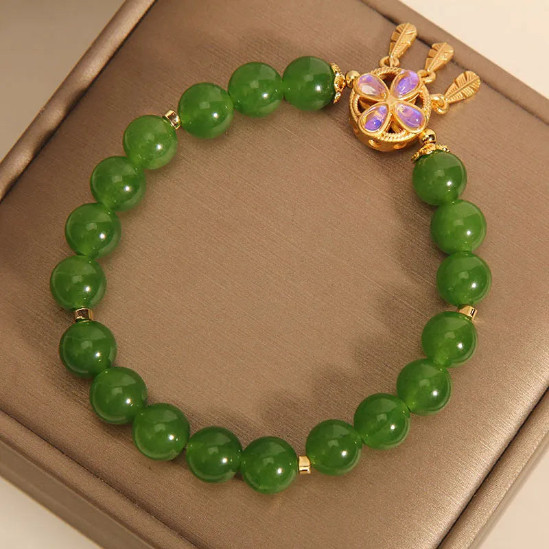 Women's green jasper crystal bracelet with four-leaf clover and dream catcher pendant, original design, on white background