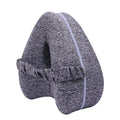 Heart-shaped dark blue jacquard memory foam leg pillow for adults on a bed.