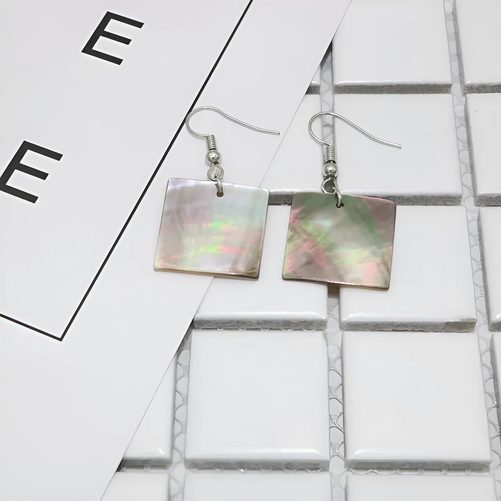 Women's geometric drop earrings made from real shell in square panther colour.