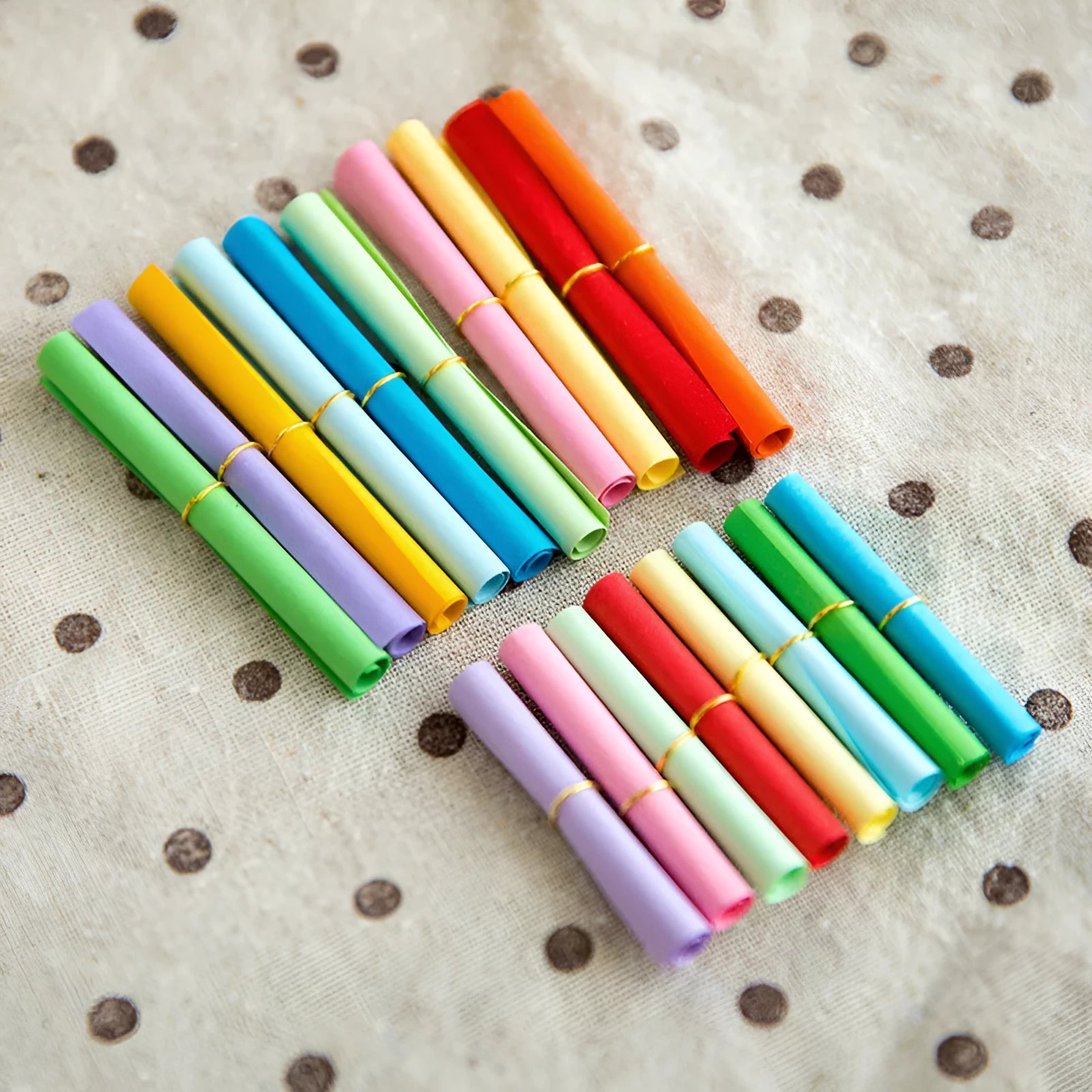 Assorted colour mini paper scrolls with metal eyelets in sizes 5x5cm, 3x7cm, 4x7cm, and 7x7cm for drift bottle messages.