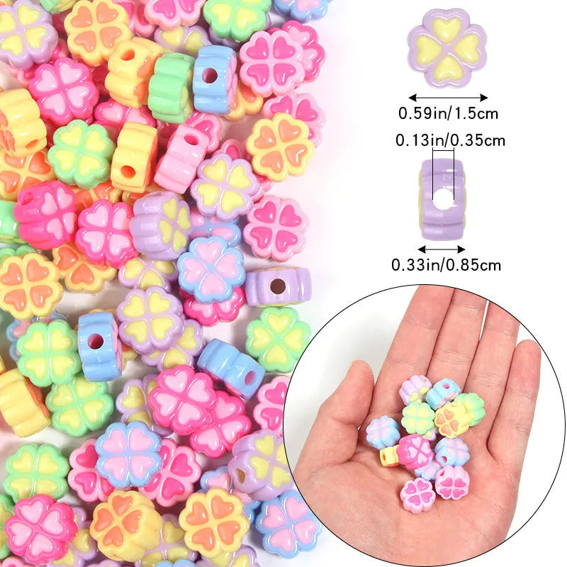 Assortment of 15mm frosted acrylic four-leaf clover craft beads in light colours.