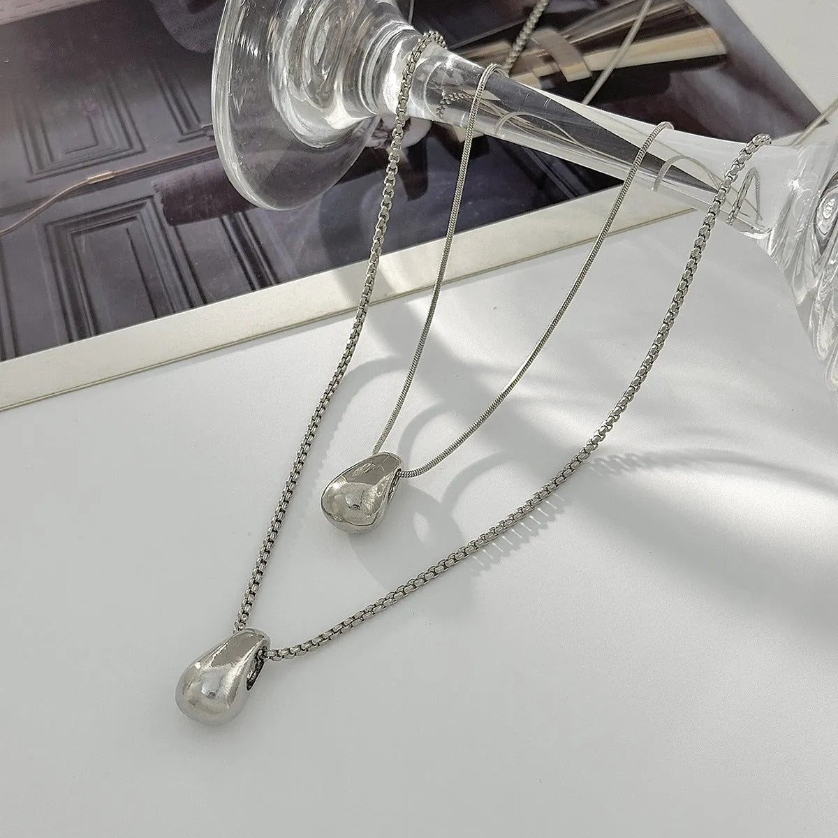 Women's geometric oval water drop pendant necklace with alloy pendant and iron chain in gold finish